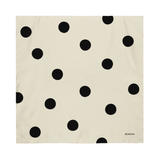 Beige fabric with black polka dot pattern on a white background