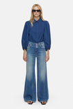 Puff Sleeve Indigo Blouse on model styled with wide leg jeans