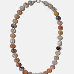 Necklace with multicolored beads on a white background