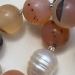 Close-up of a bracelet with multicolored beads on a white background