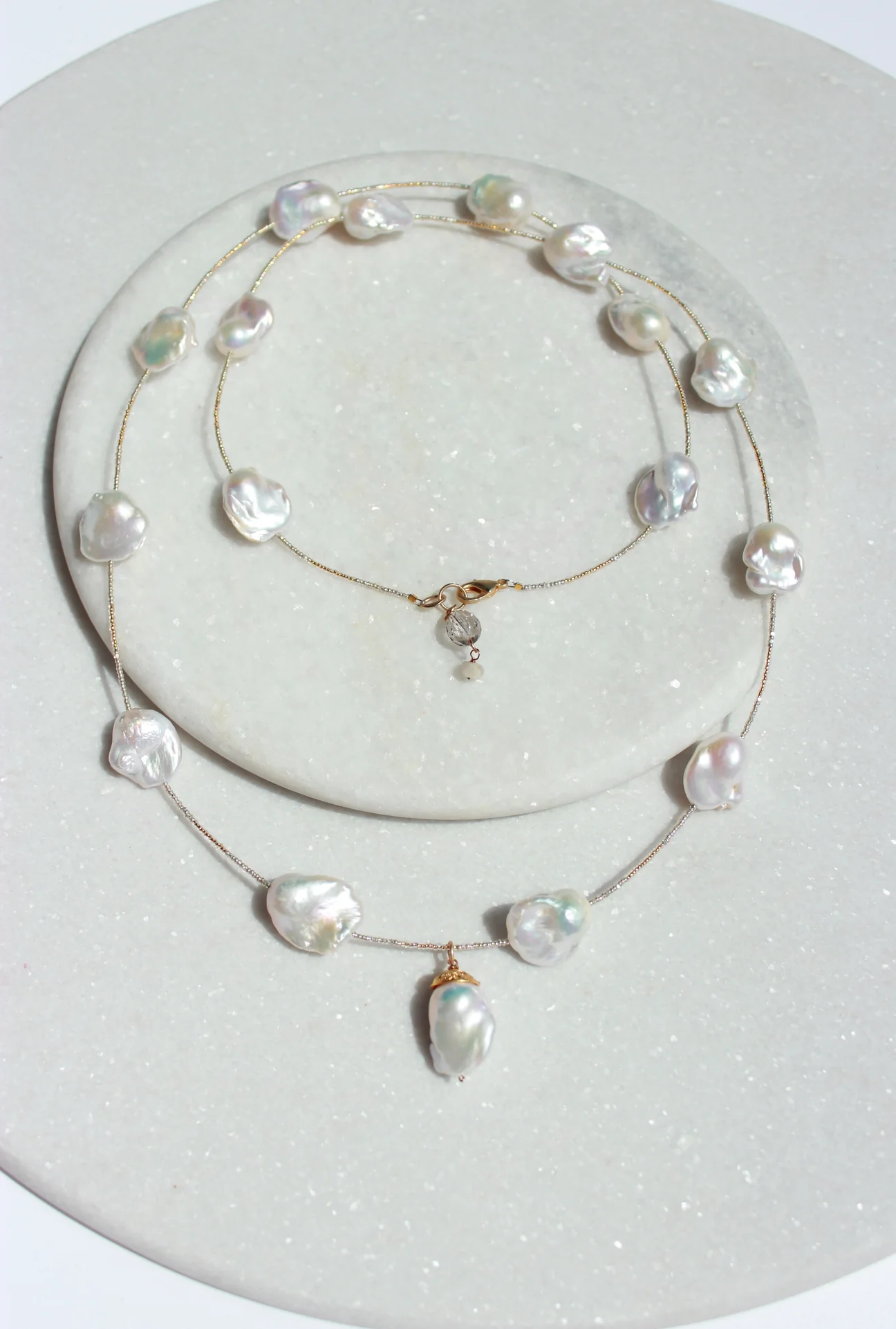 Pearl necklace on a white plate