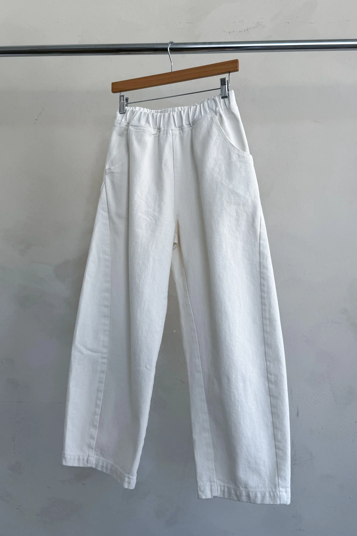 Arc Pants - Milk hanging on hanger