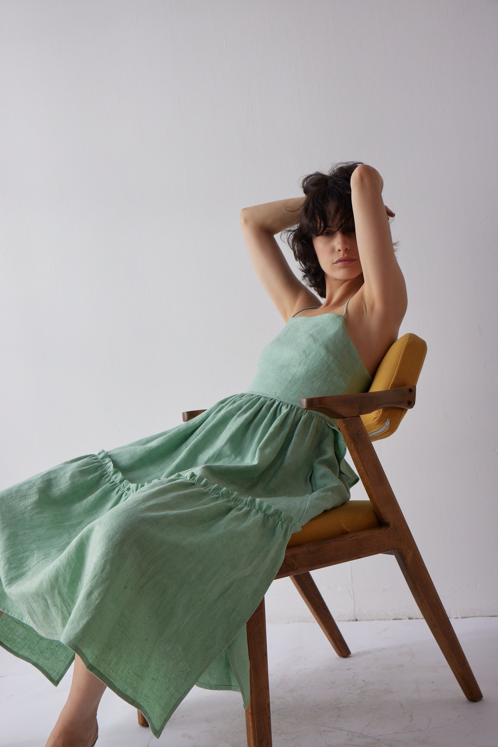 Holly Dress - Green imaged on model in chair