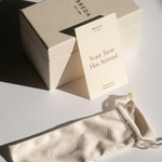 Breda box with a card and a watch pouch on a light surface