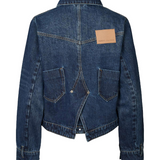 Blue denim jacket with a brown patch on a white background
