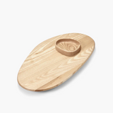 Wooden serving board with a central circular compartment on a white background