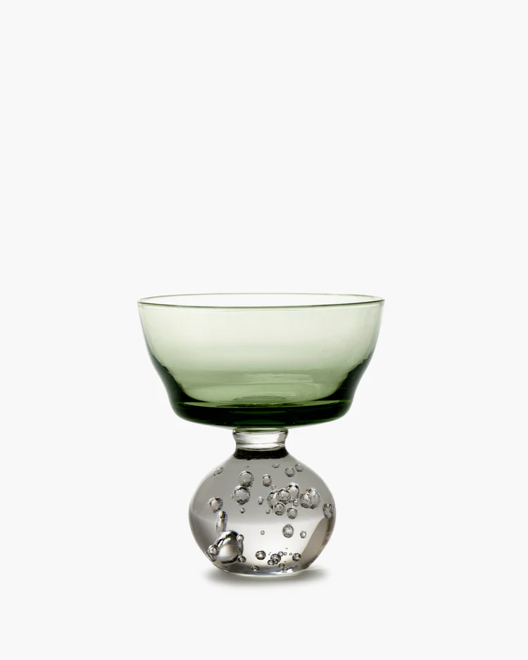 Green glass bowl with bubble design on a white background