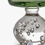 Close-up of a glass with bubbles on a white background