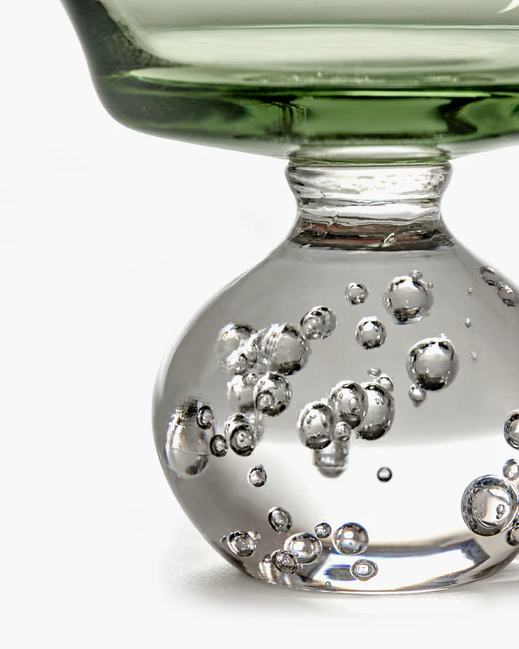 Close-up of a glass with bubbles on a white background