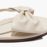 Beige sandal with a bow on a white background