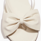 White sandal with a large bow on a white background