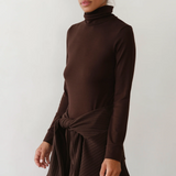 image of side view of brown turtleneck on model