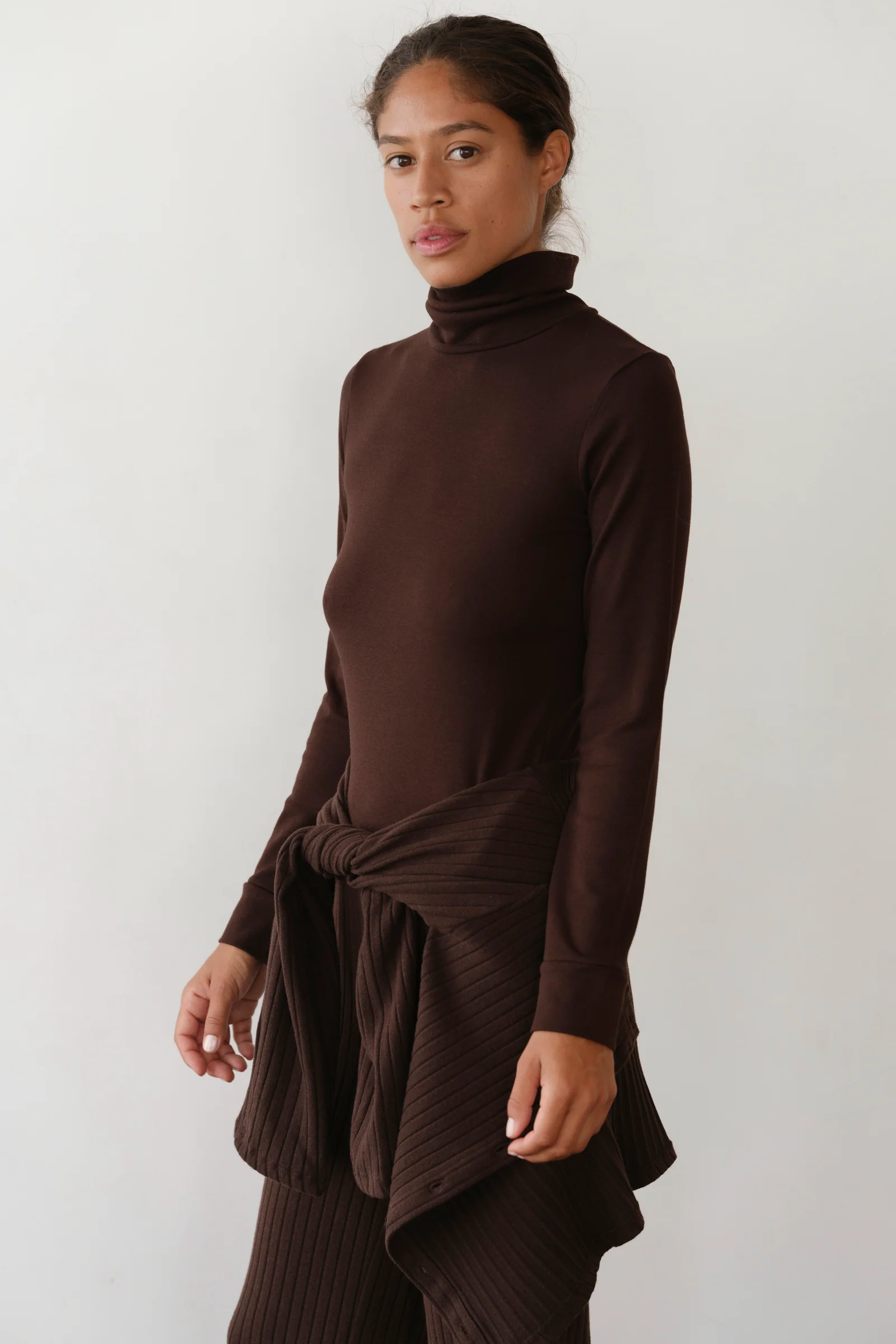 image of side view of brown turtleneck on model
