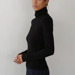image of side view of model wearing black turtleneck