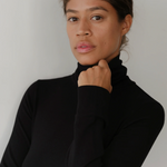 close up of model in black turtleneck