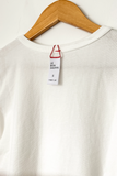 close up view of the collar and tag on the Little Boy Tee - Vintage White