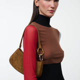 Model carrying the STAUD Ollie Bag in Cigar suede on the shoulder
