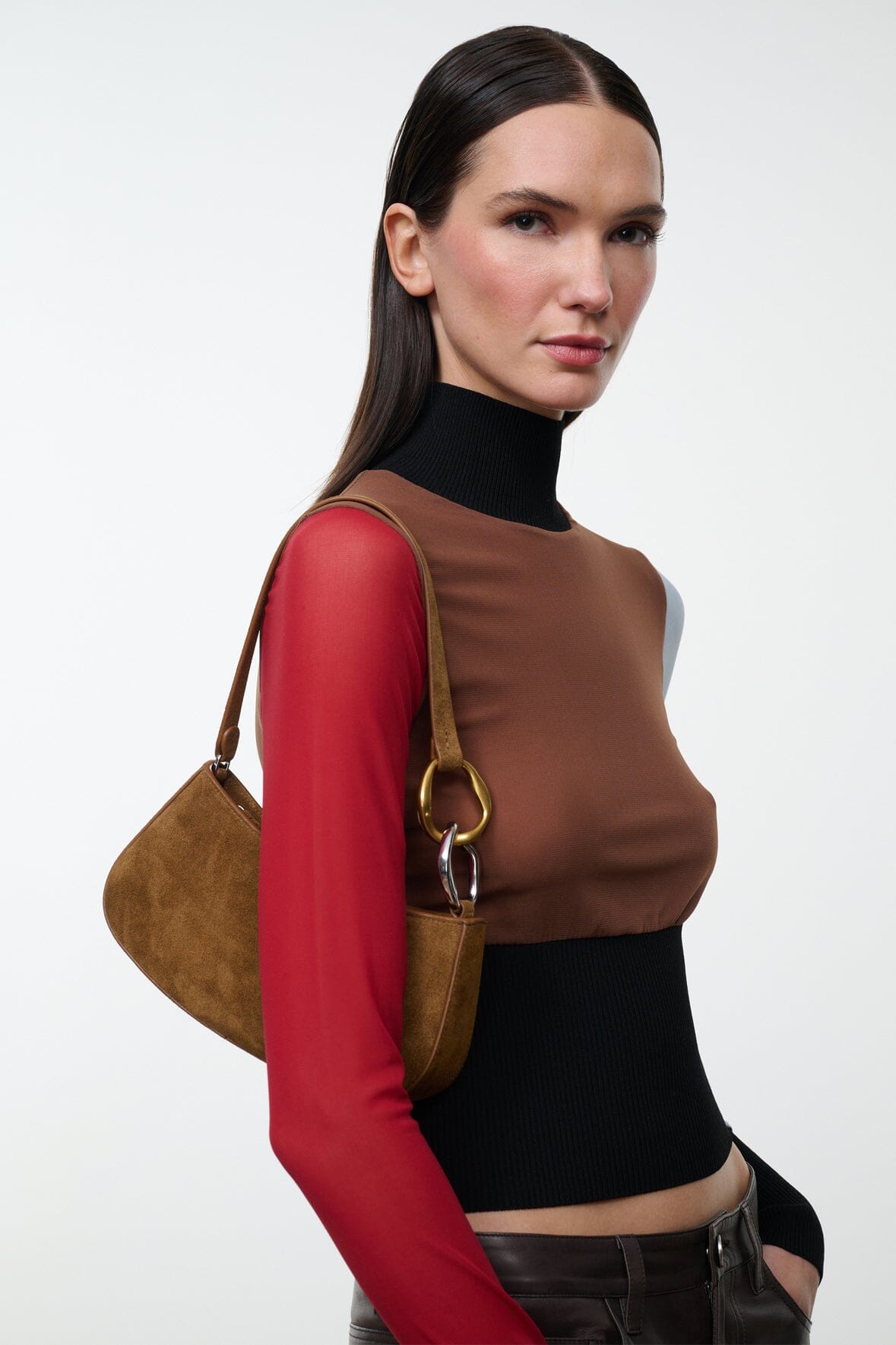Model carrying the STAUD Ollie Bag in Cigar suede on the shoulder