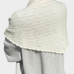 JONES + CO pearl mohair pointelle shawl with delicate scalloped edges draped over shoulders outdoors