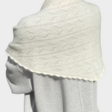 JONES + CO pearl mohair pointelle shawl with delicate scalloped edges draped over shoulders outdoors
