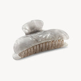 Shell-style hair clip on a white background