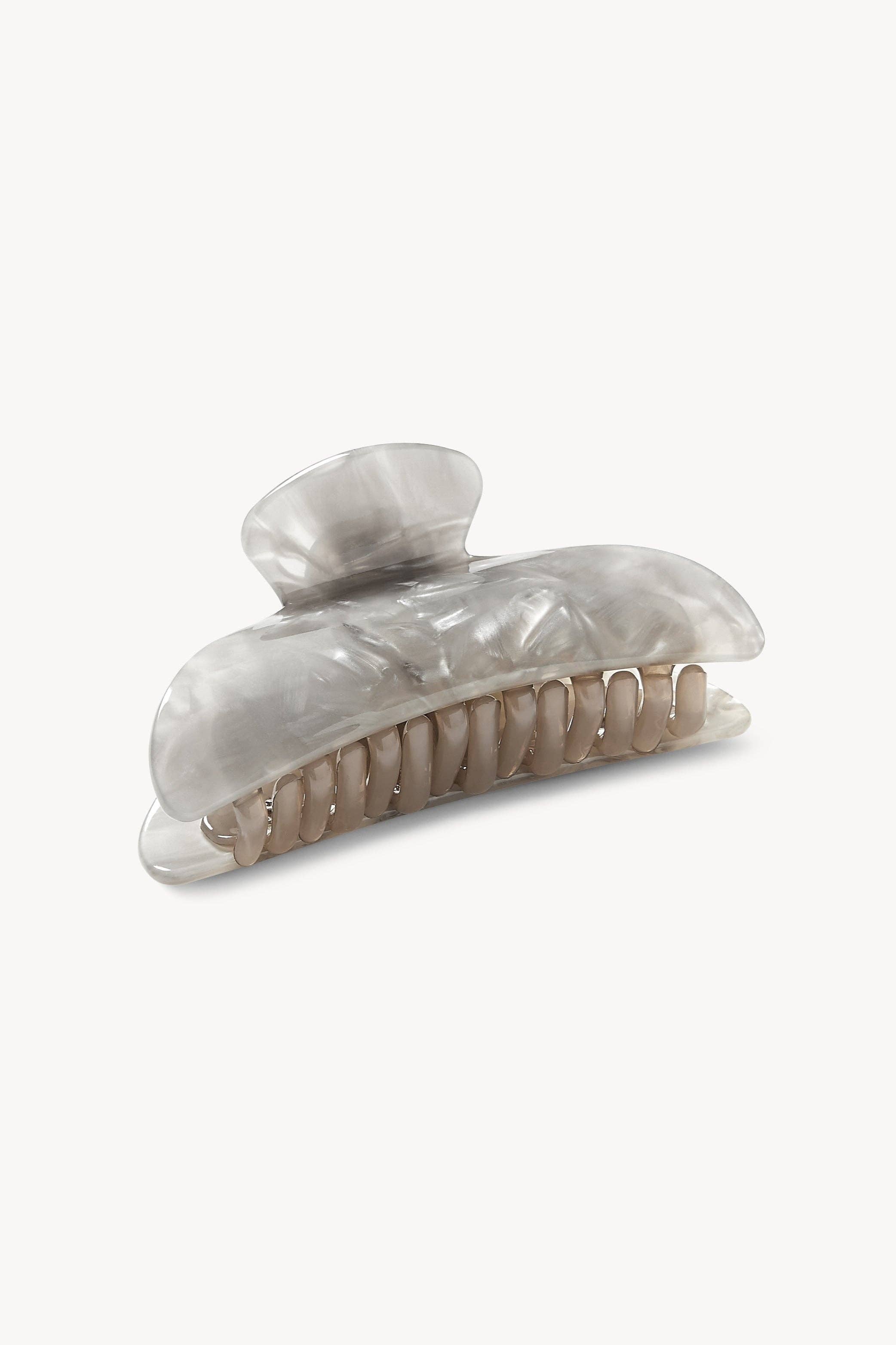 Shell-style hair clip on a white background