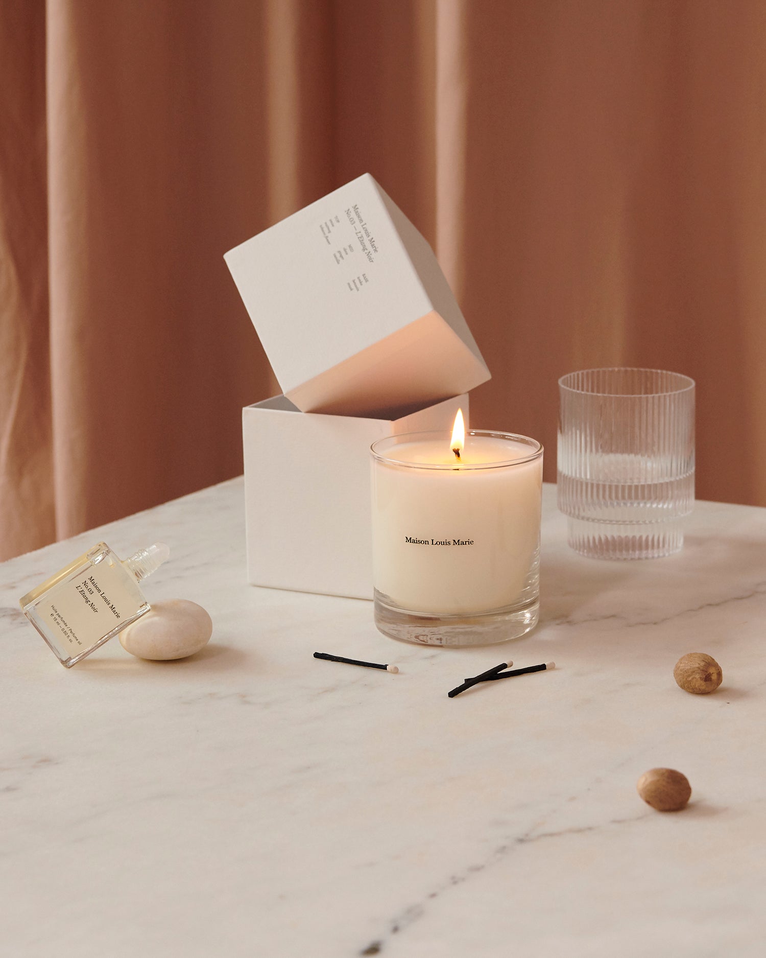 Maison Louis Marie No.03 L'Etang Noir Candle — lifestyle with perfume oil