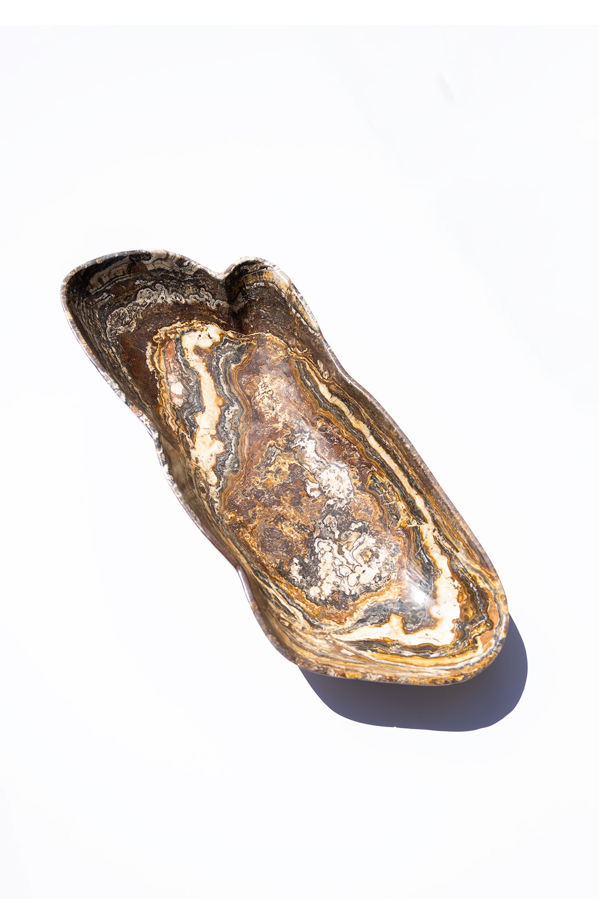 large onyx brown and white marbled bowl on a white background