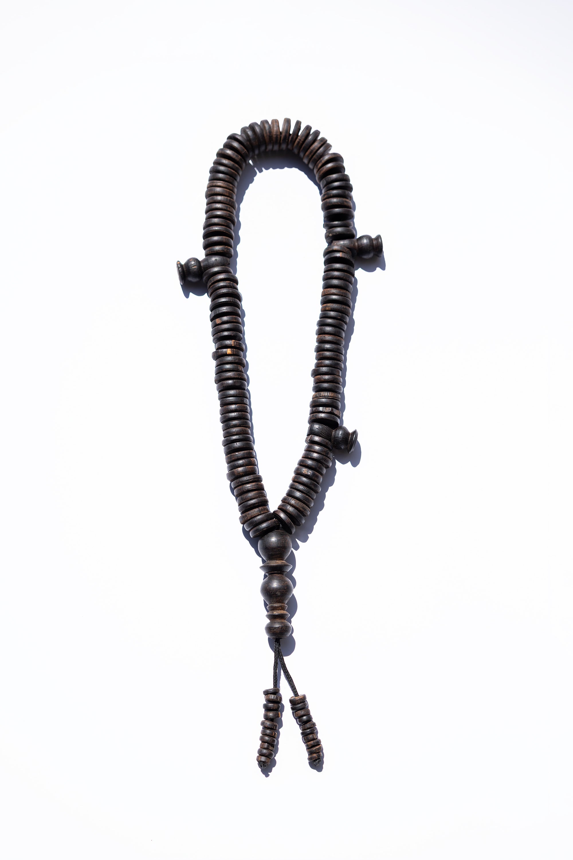 Wooden rosary on a white background