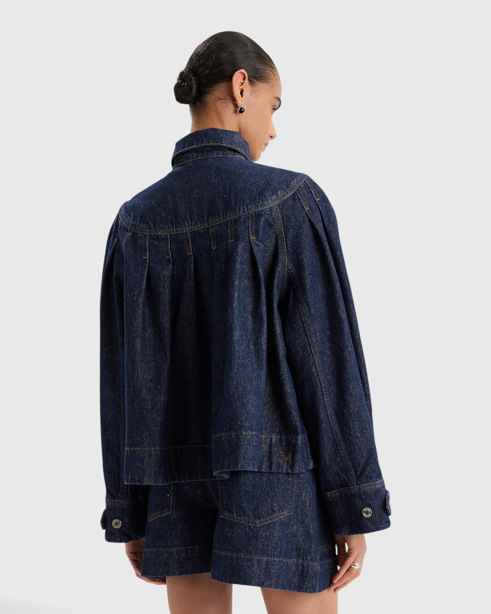 Merlette Easton Jacket in Dark Wash - back view showing the embroidered Merlette M on the back hem
