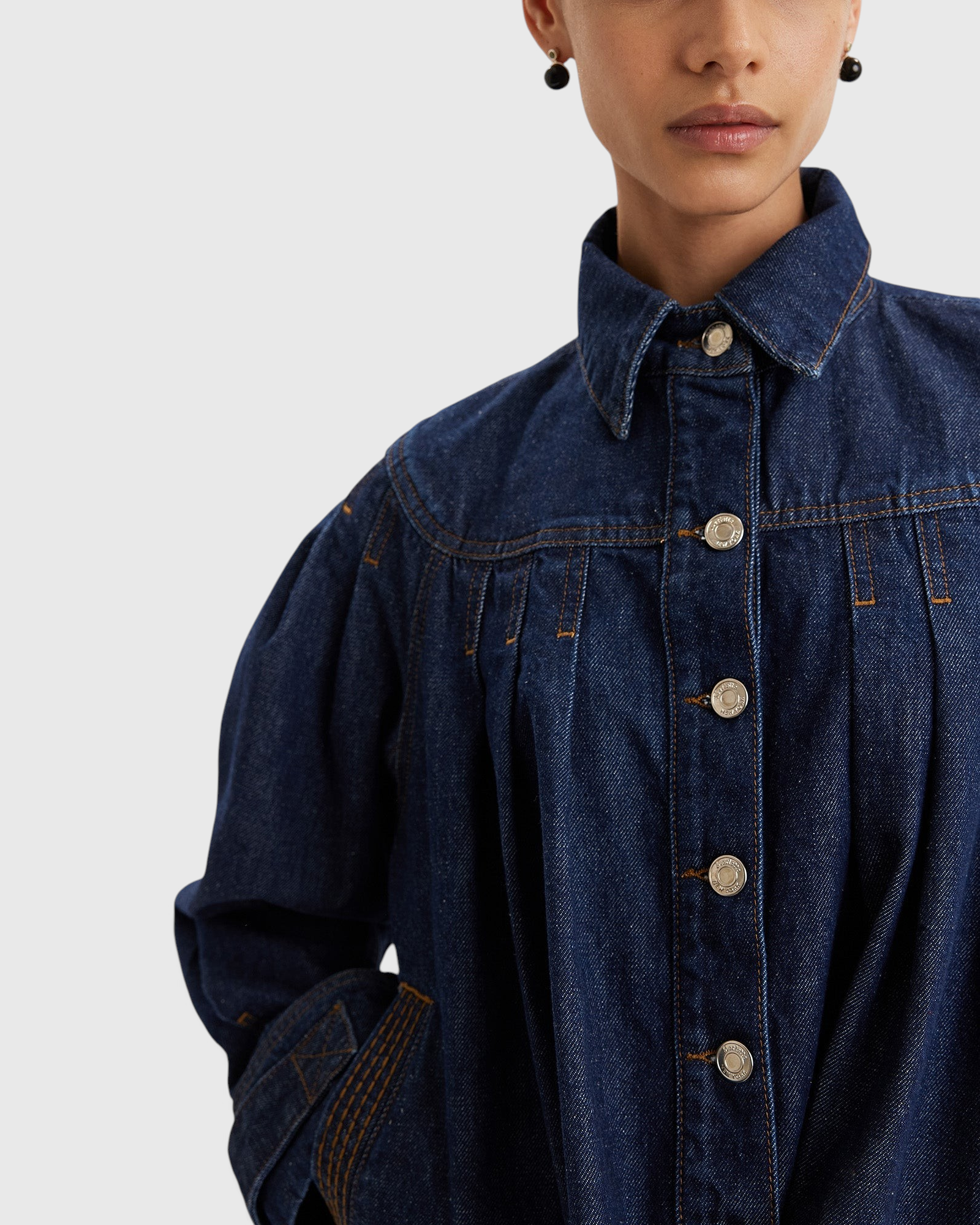 Merlette Easton Jacket in Dark Wash - close detail of the point collar, custom hardware and contrast stitching