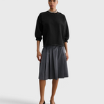 JONES + CO Rachel Comey Fond Sweatshirt in charcoal, full-length front view styled with a pleated skirt
