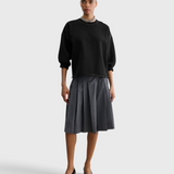 JONES + CO Rachel Comey Fond Sweatshirt in charcoal, full-length front view styled with a pleated skirt