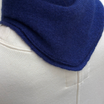 JONES + CO navy blue cashmere and wool blend bandana scarf worn around the neck over a cream sweatshirt