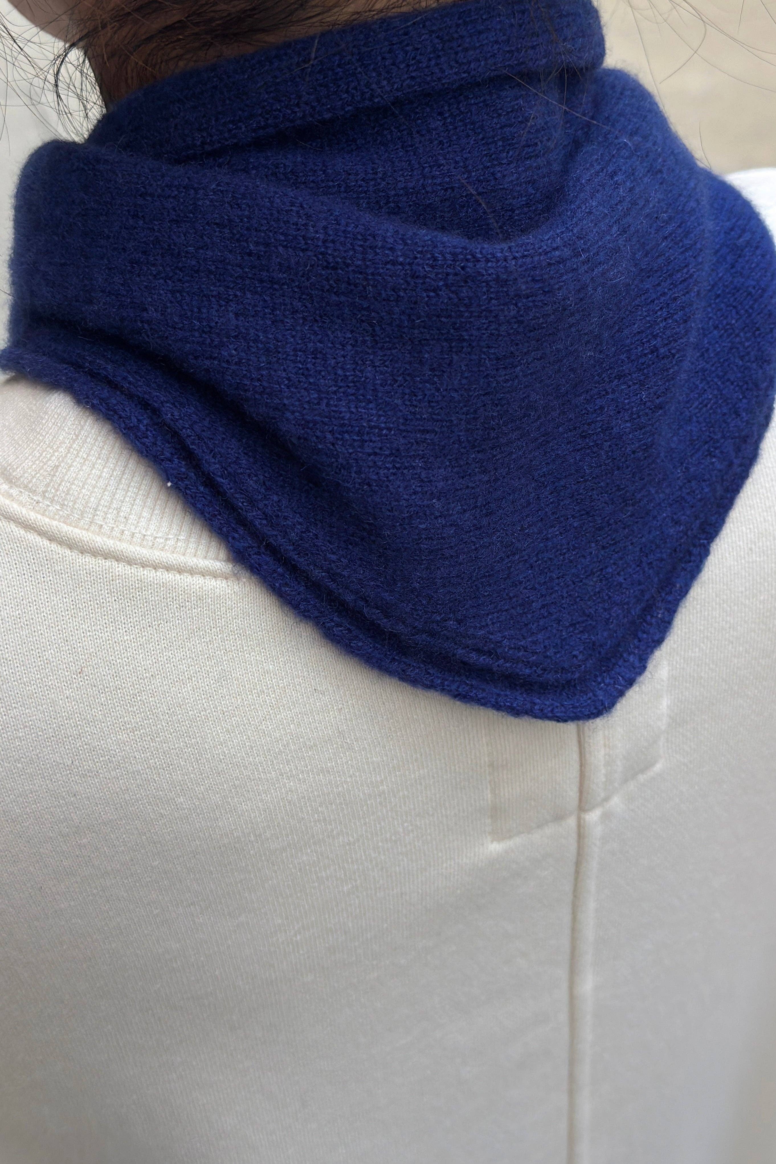JONES + CO navy blue cashmere and wool blend bandana scarf worn around the neck over a cream sweatshirt