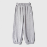 JONES + CO melange grey French terry balloon pants with an elastic high waist and gathered leg openings.