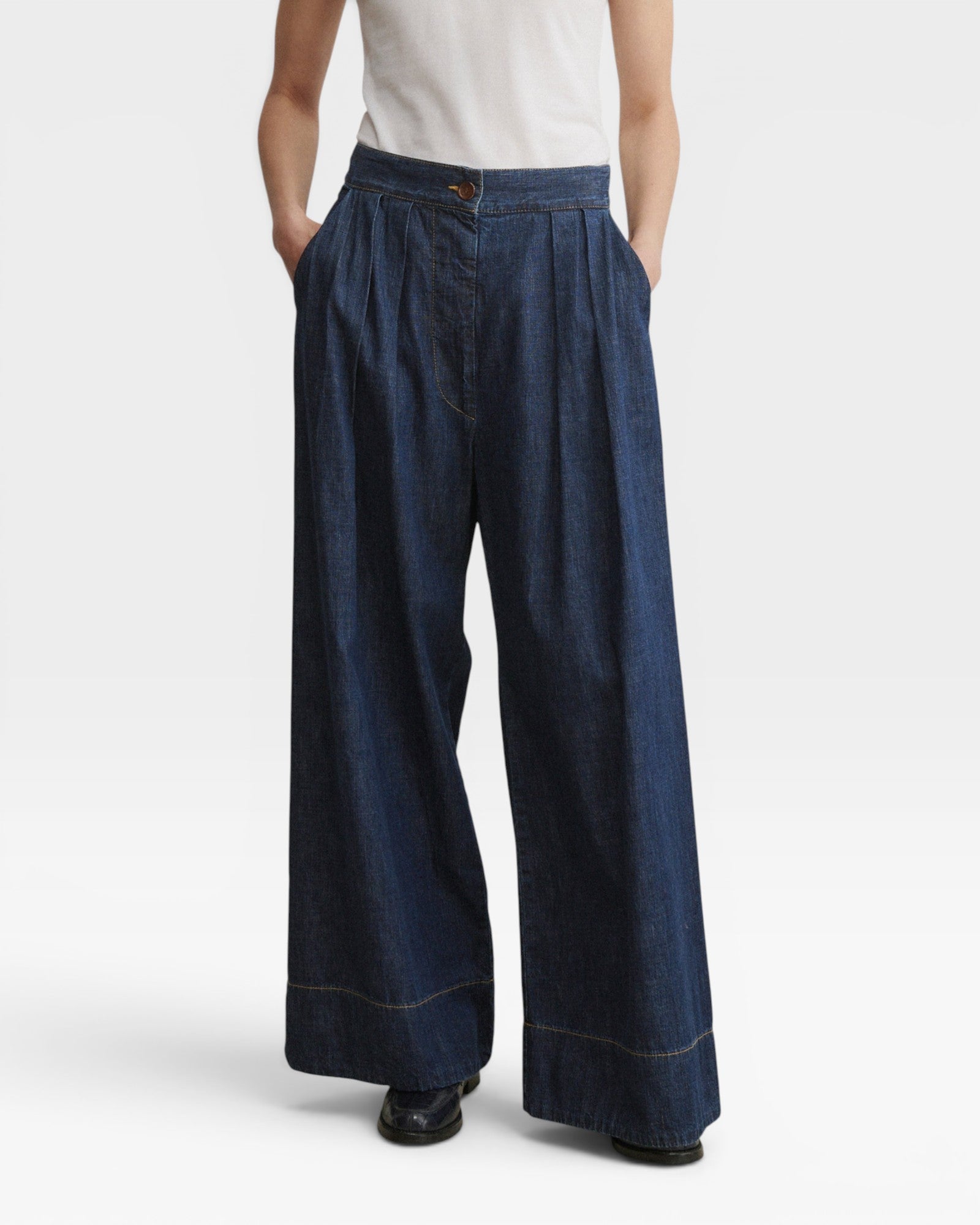 JONES + CO Coxsone dark indigo denim trousers, front view with hands in side slip pockets.