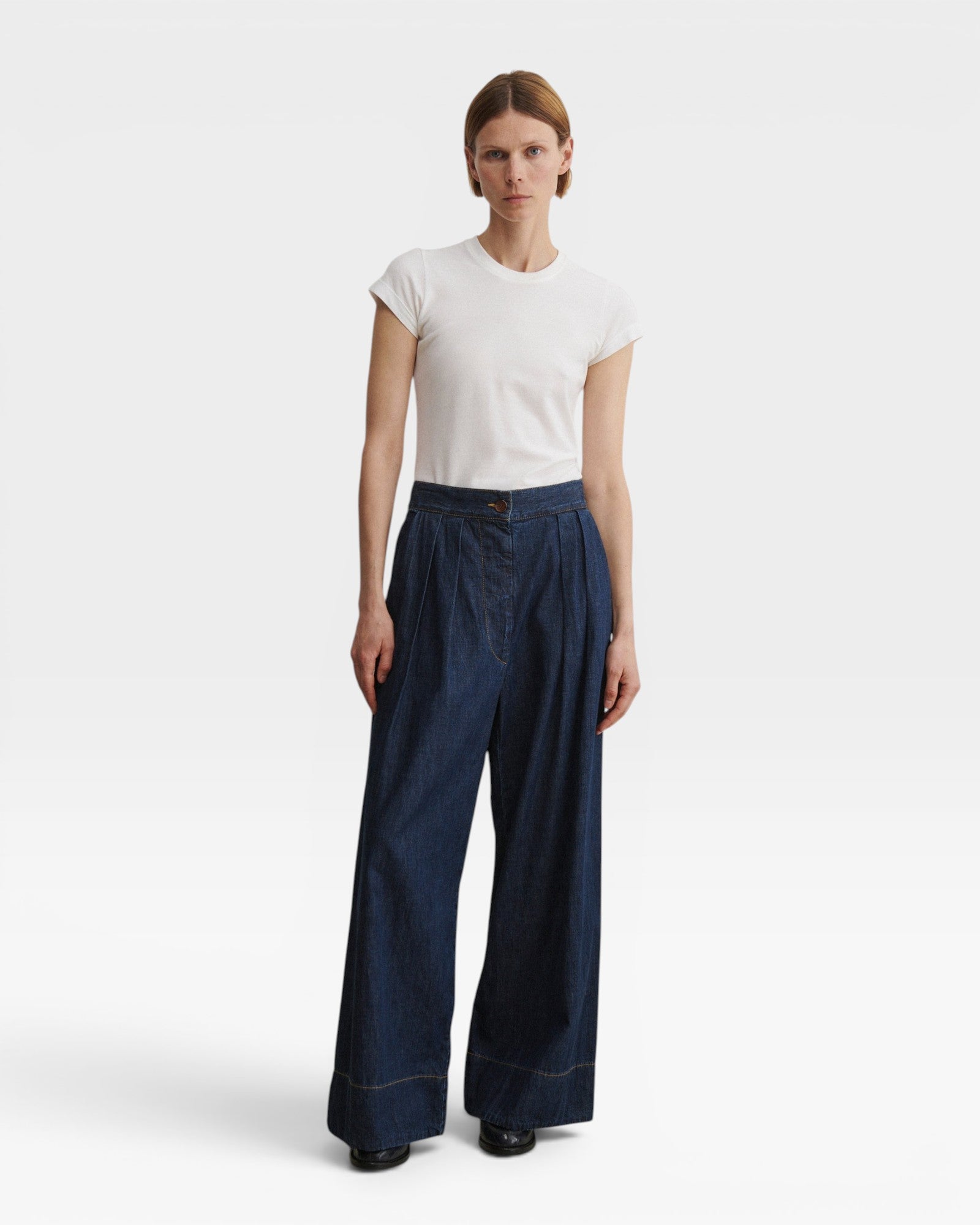 JONES + CO Coxsone high-waisted wide-leg pleated trousers in dark indigo Vista denim, full-length front view.