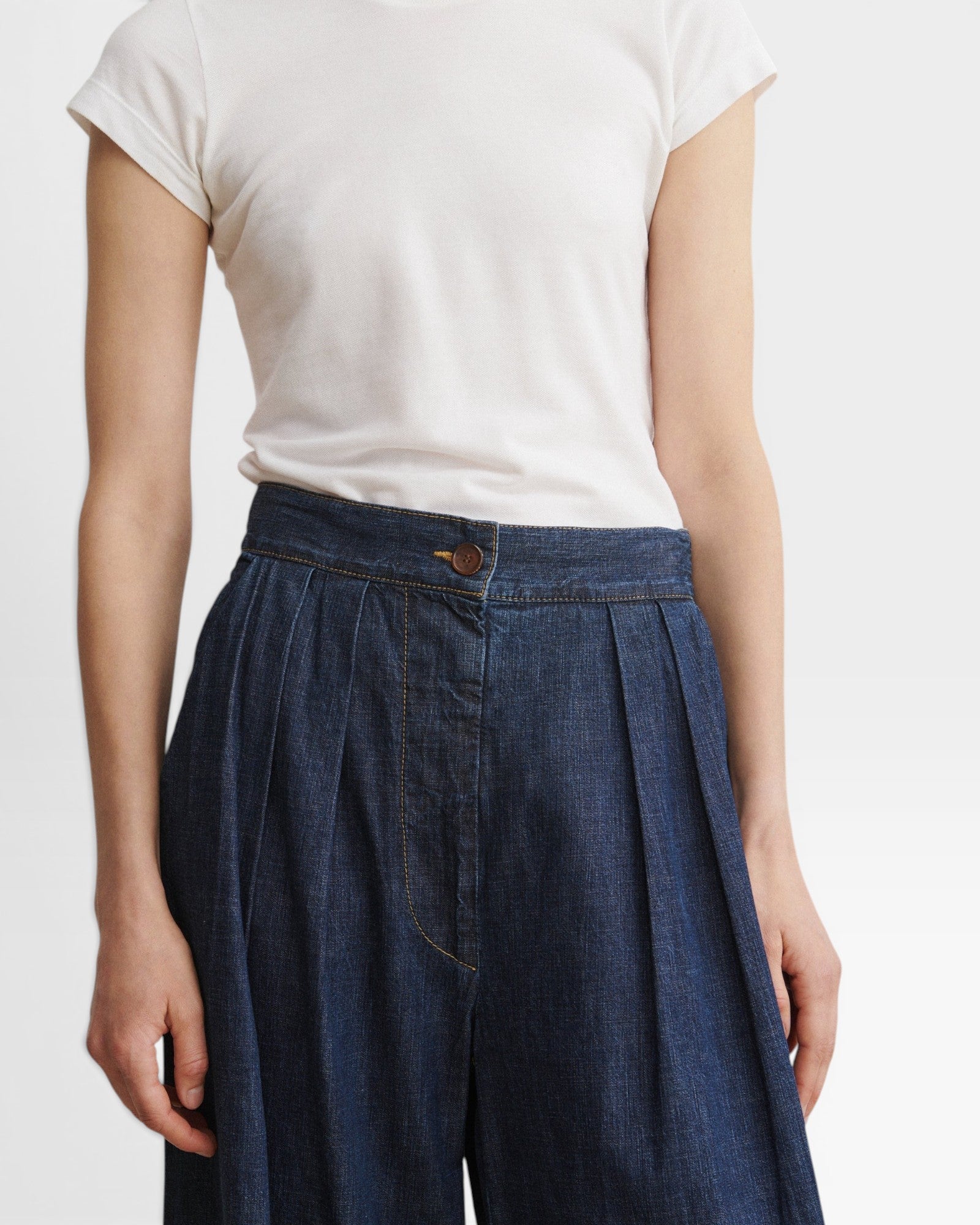 JONES + CO Coxsone dark indigo denim trousers, detail of high waist, front pleats and faux button fly.