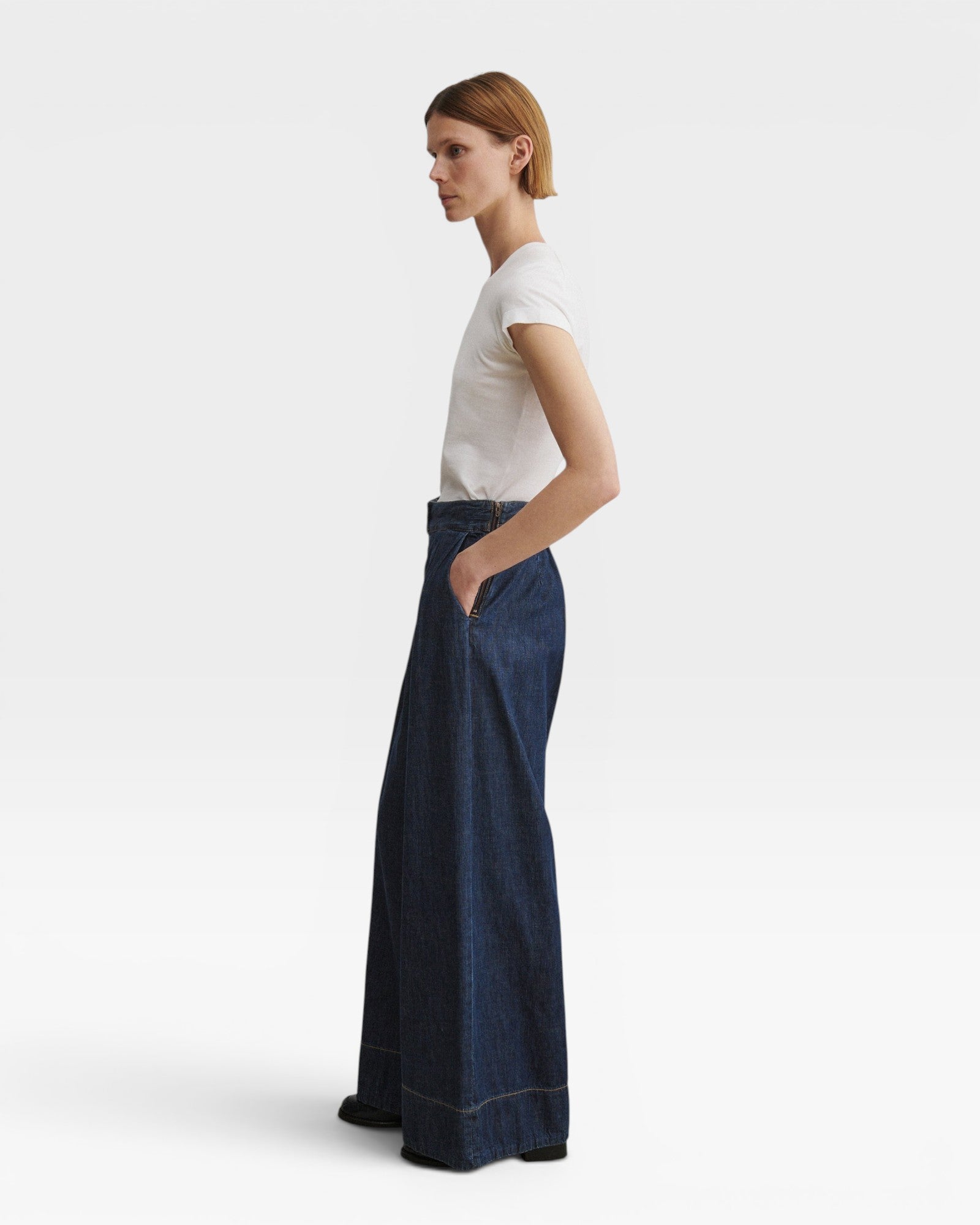 JONES + CO Coxsone dark indigo denim trousers, side view showing wide leg.