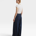 JONES + CO Coxsone dark indigo denim trousers, back three-quarter view with elastic back waistband.