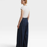 JONES + CO Coxsone dark indigo denim trousers, back three-quarter view with elastic back waistband.