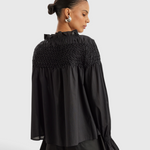 Merlette Majorelle Top in Black - back view showing the hand smocked yoke