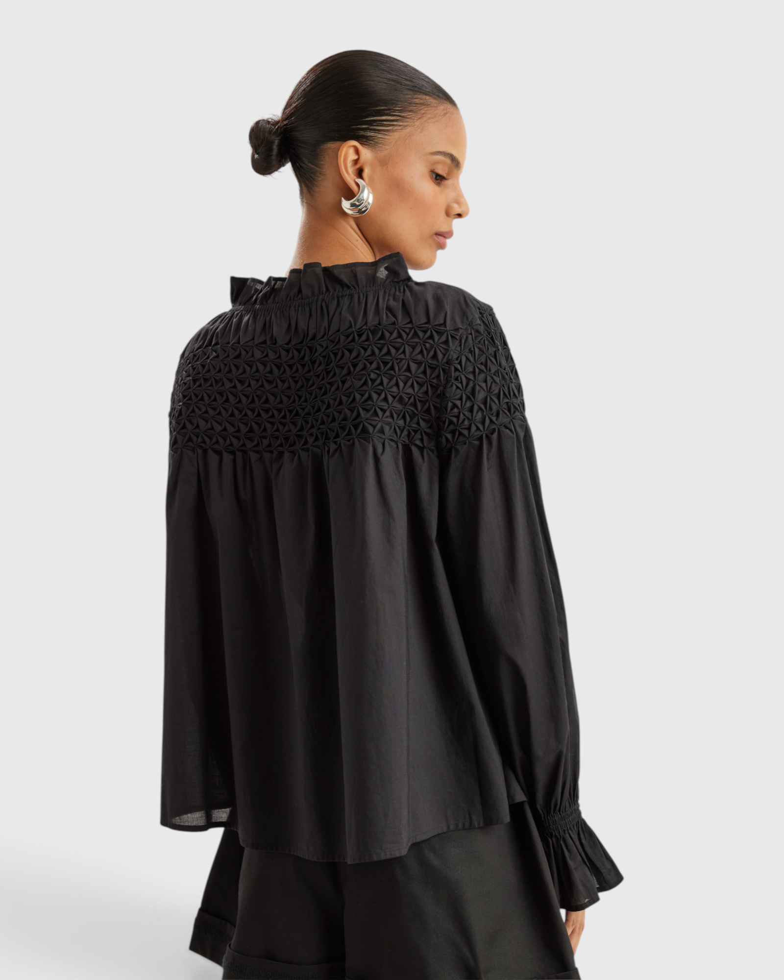 Merlette Majorelle Top in Black - back view showing the hand smocked yoke