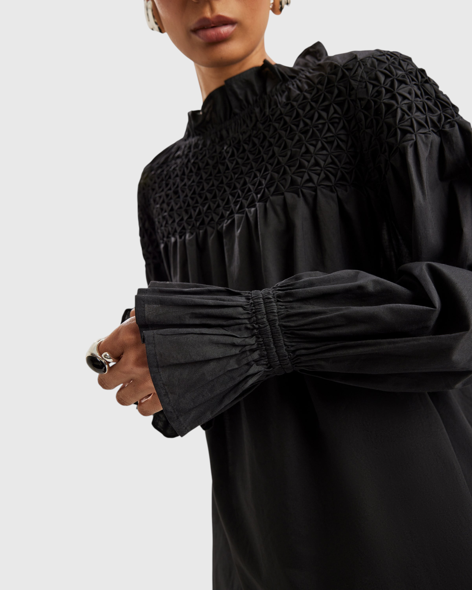 Merlette Majorelle Top in Black - close detail of the smocked yoke and elasticated ruffled cuff