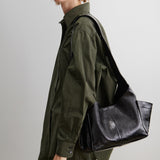 RACHEL COMEY Tool Bag in black leather, side view showing extended exterior pocket.