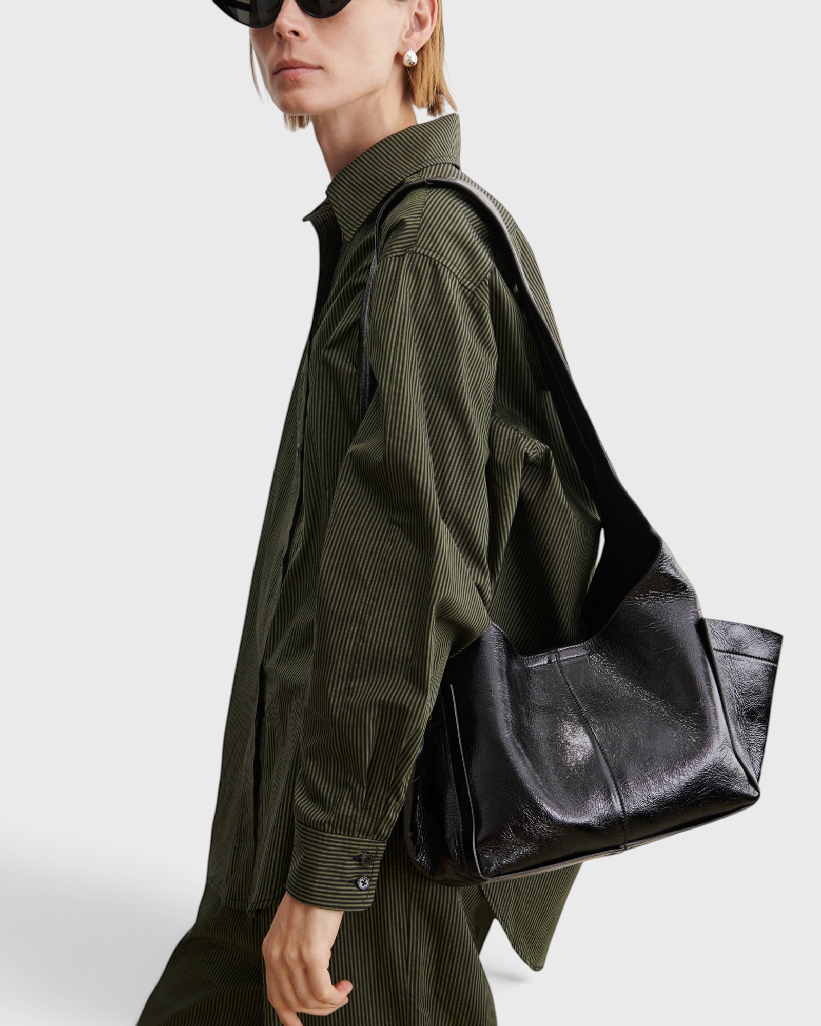 RACHEL COMEY Tool Bag in black leather, side view showing extended exterior pocket.
