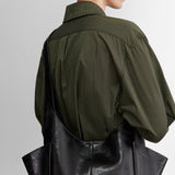 Model carrying the RACHEL COMEY Tool Bag in black leather over the shoulder.