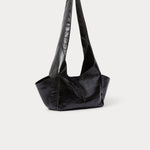 Model wearing the RACHEL COMEY Tool Bag in black leather, styled look.