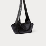 Model wearing the RACHEL COMEY Tool Bag in black leather, styled look.